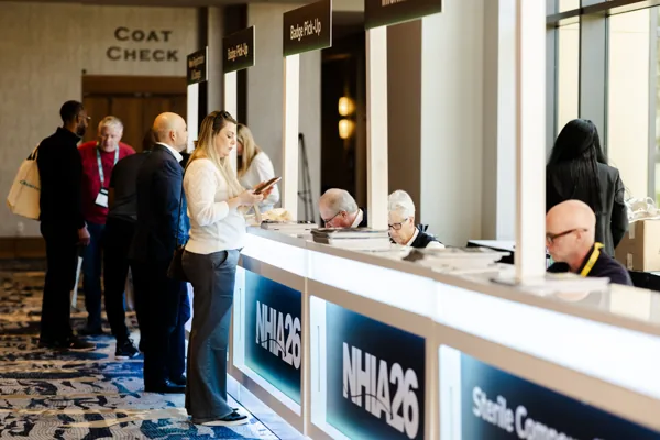 Attendees check in at the NHIA26 registration desk.